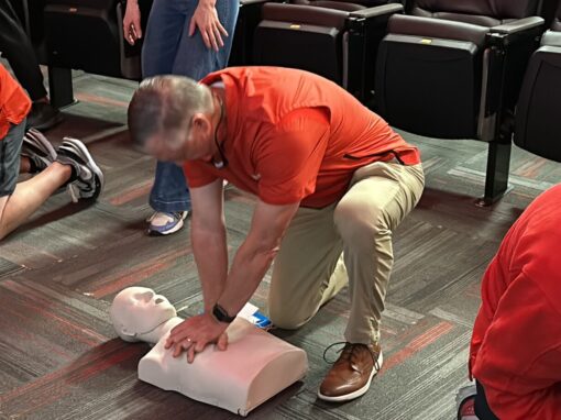 Coach Willie Fritz, University of Houston Head Football Coach performing Hands Only CPR